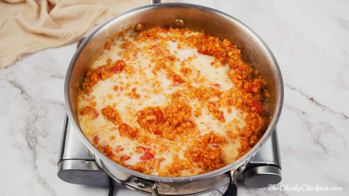 coconut milk on top of lentils in saucepan