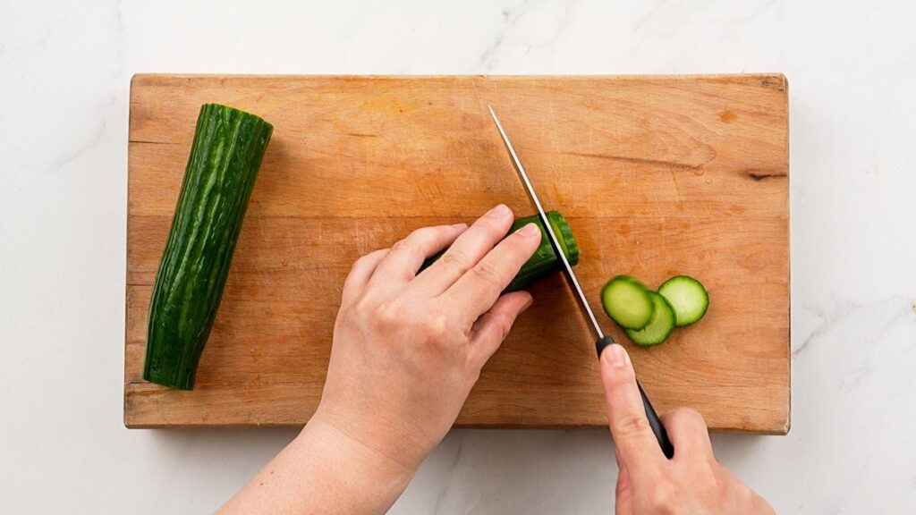 cucumber being sliced