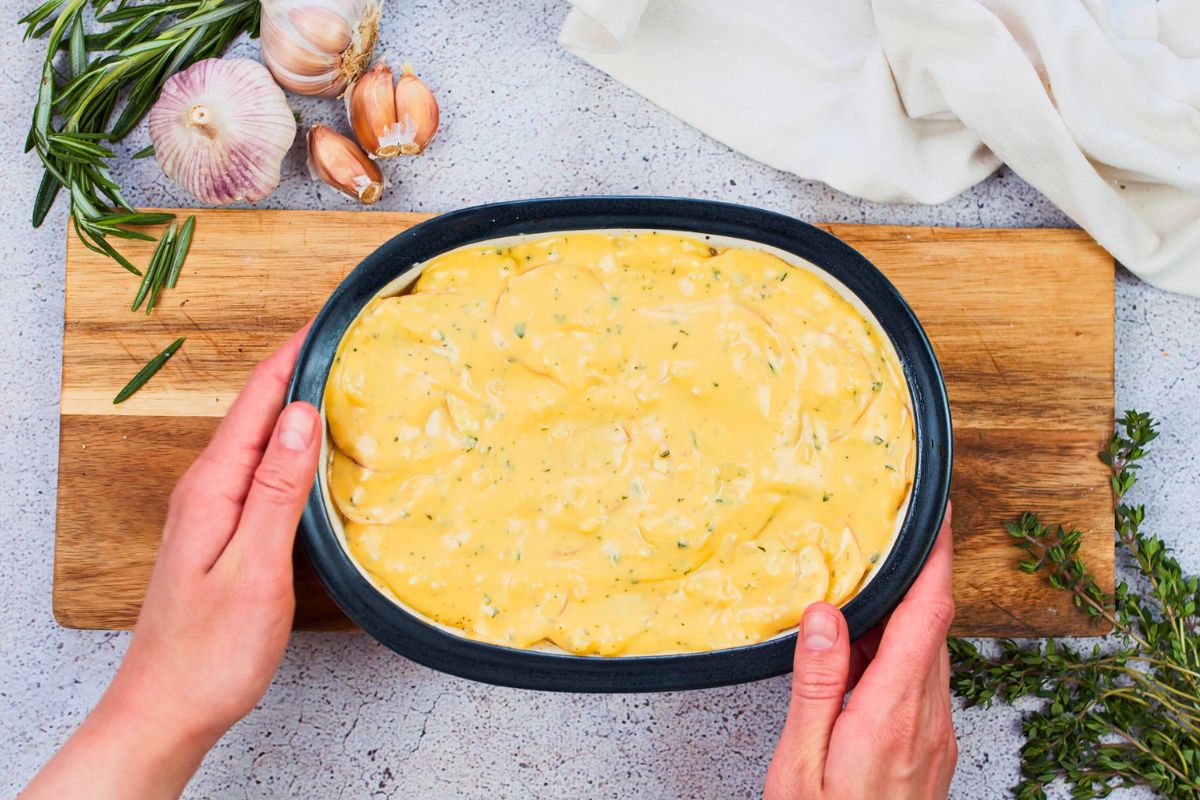 baking dish of scalloped potatoes before baking