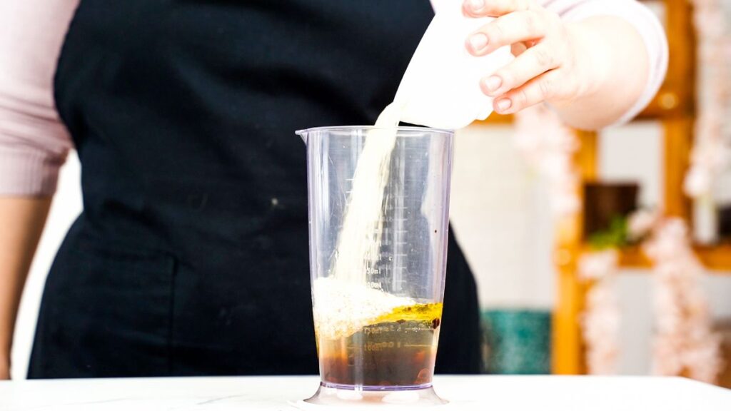 cream being added to blender of salad dressing