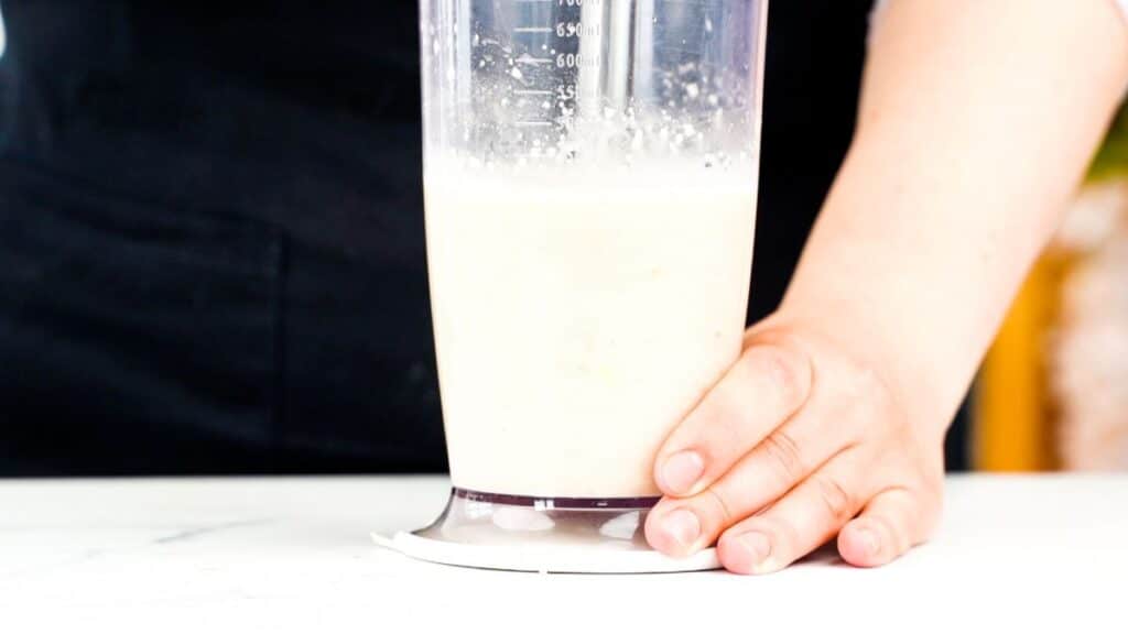 creamy dressing being pureed in blender