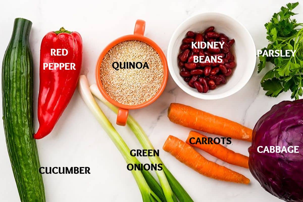 vegetables on table by bowl of uncooked quinoa