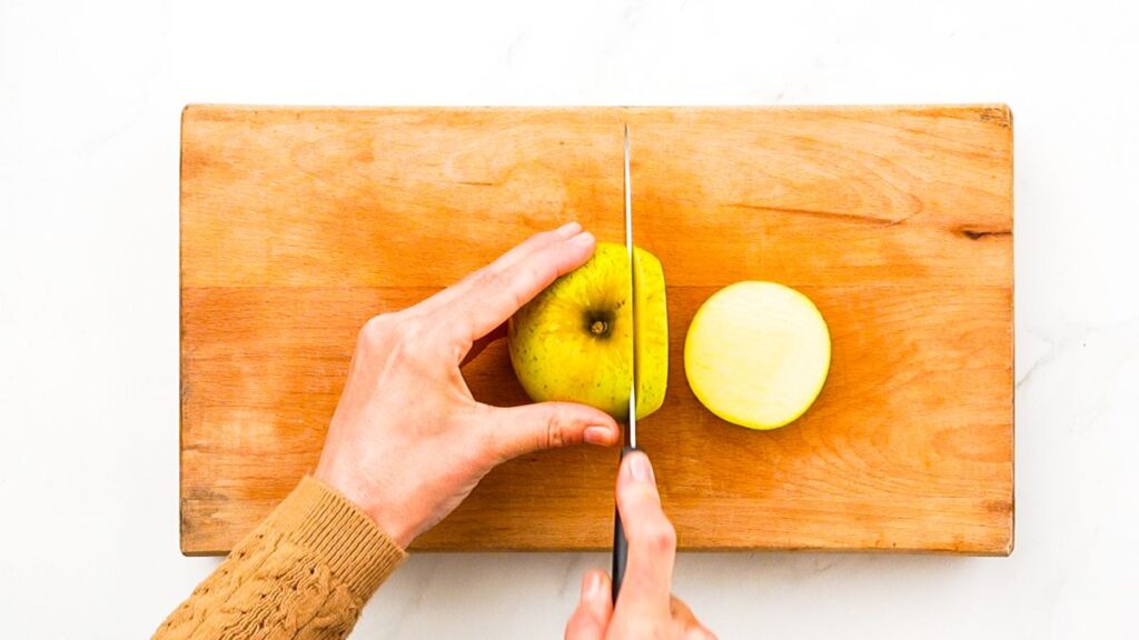 slicing apple on cutting board