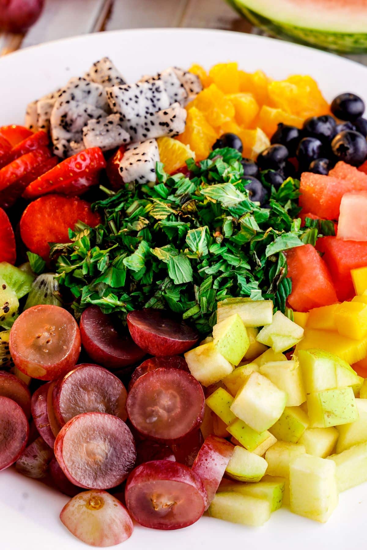 chopped fruit layered on white plate