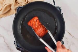 skillet on hot plate holding vegan salmon