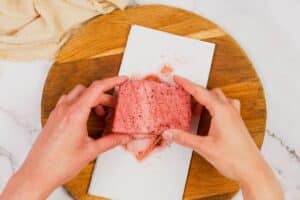 patting tofu block dry with paper towels