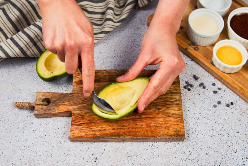 spoon scooping avocado out