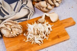 shredded mushrooms on wood cutting board