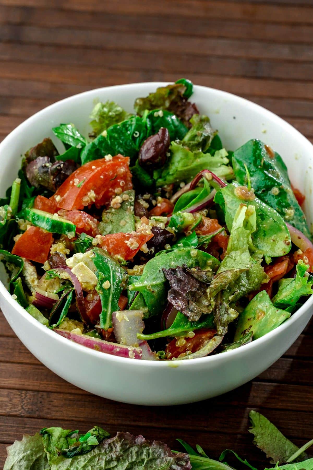 large white bowl of salad on wood table