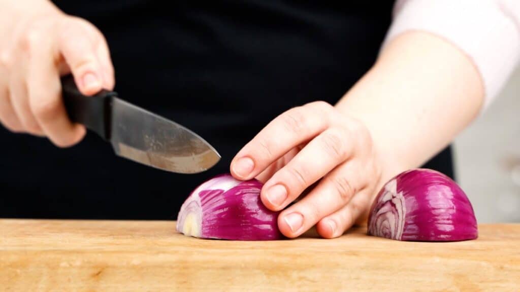 chopping onion on cutting board