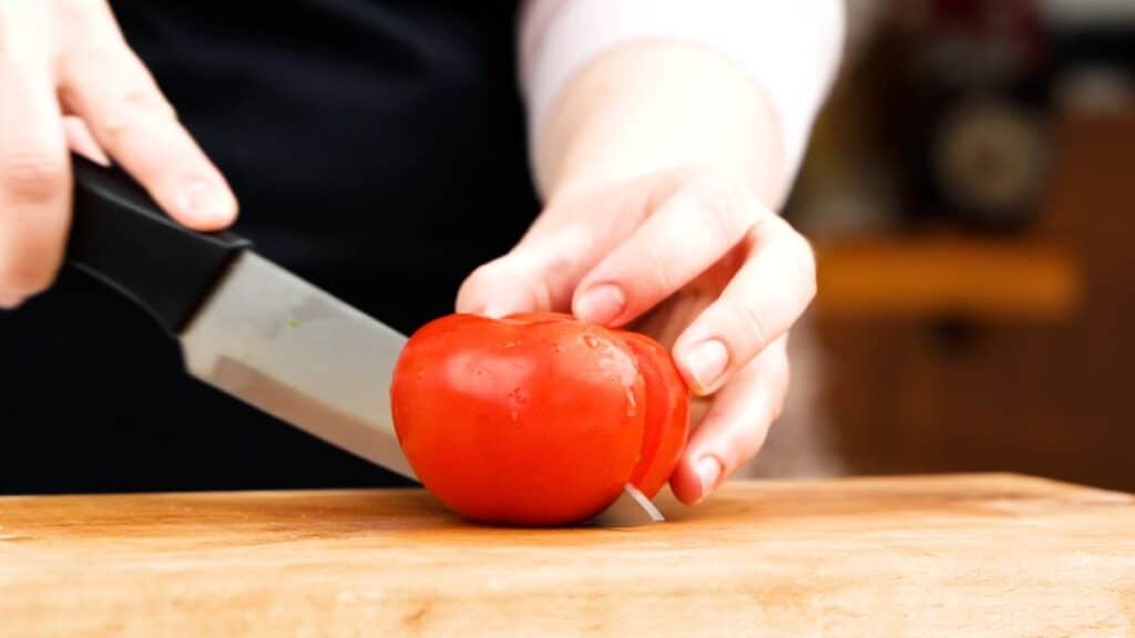 tomato being cut in half