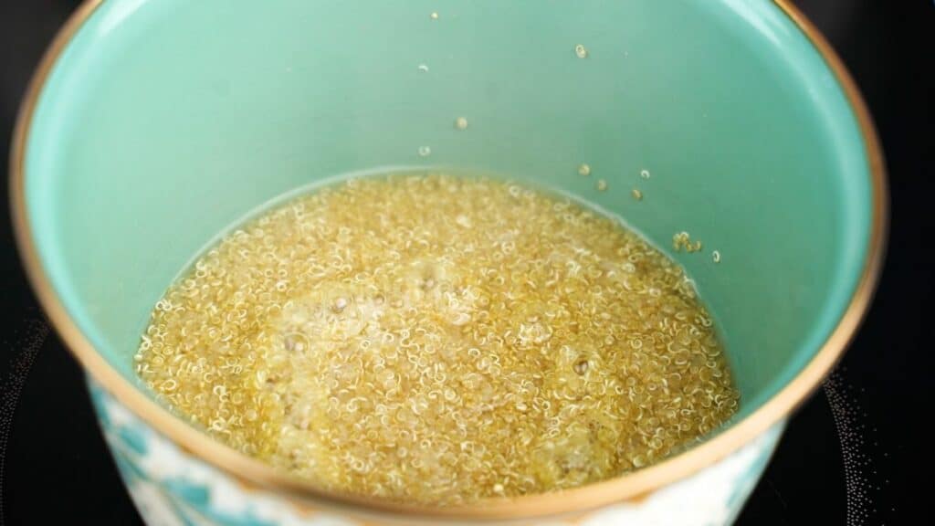 quinoa cooking in teal saucepan
