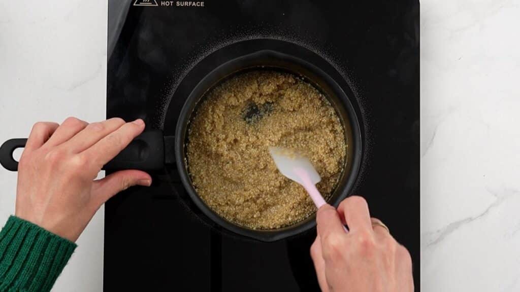 quinoa being cooked in saucepan