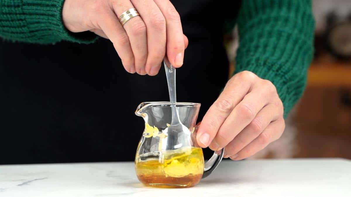 dressing being stirred in small jar